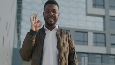 smiling man giving ok sign