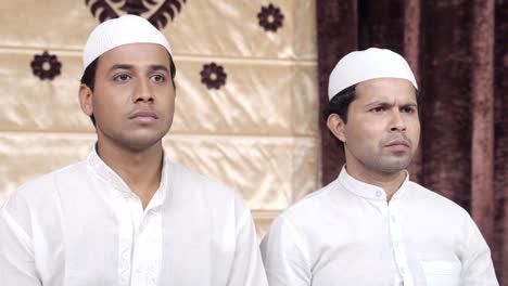 Two-serious-Indian-Muslim-men-staring-at-something