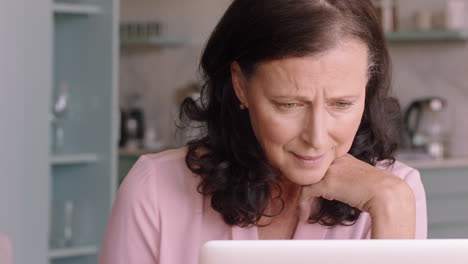 happy-mature-woman-using-laptop-at-home-browsing-online-enjoying-reading-social-media-messages-on-computer