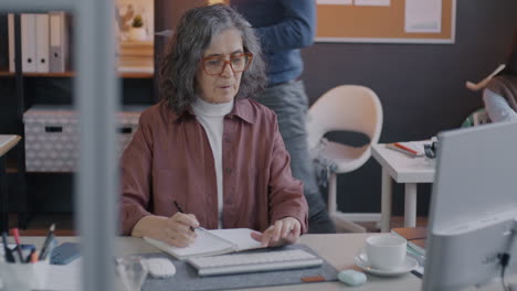 senior woman working at her desk in an office