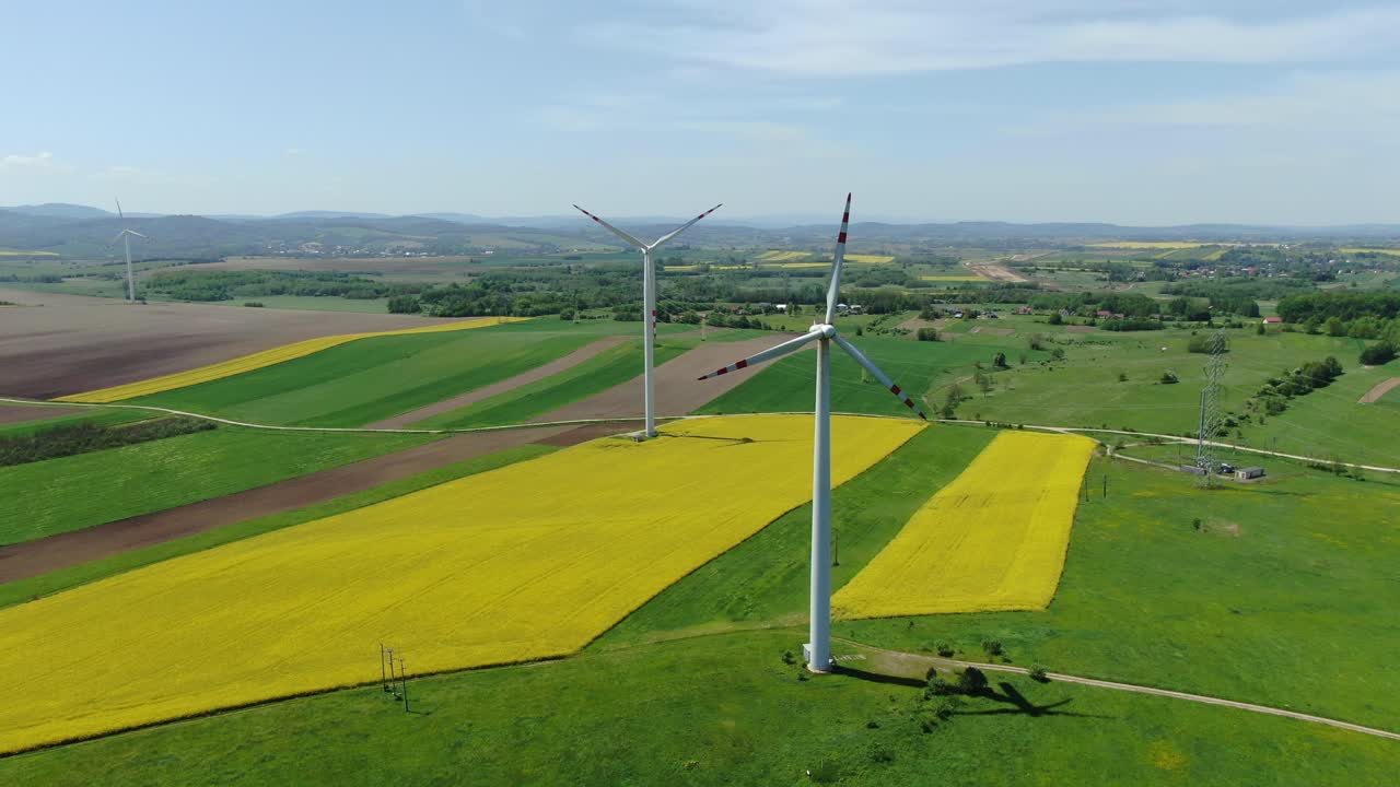 воздушная орбита вокруг двух ветряных турбин в ветряной ферме в польше над желтыми полями