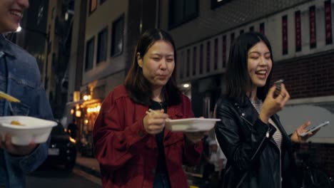 friends enjoying street food at night