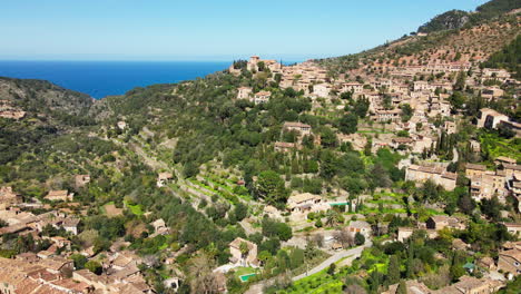 aerial reveal of historic village deia mallorca