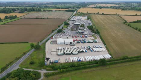aerial orbiting drone footage of busy truck stop, service station with heavy goods vehicles near lutterworth leicestershire england uk