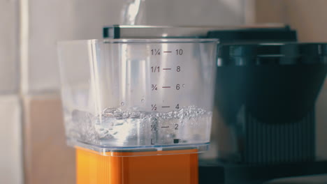 filling the water reservoir of the coffee machine