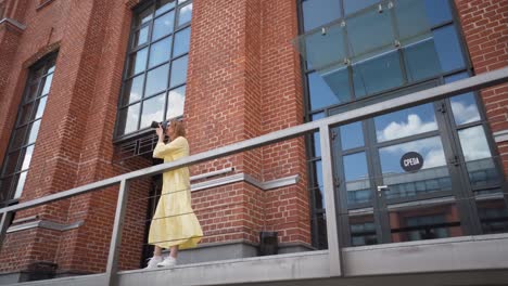 woman photographing a cityscape