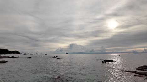 the sun shines through dramatic clouds over an ocean during the golden hour, creating a breathtaking scene with tranquil waters reflecting vibrant colors