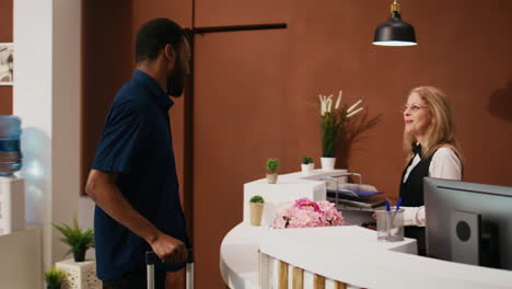 hotel guest entering lobby with luggage