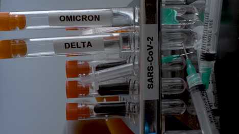 sars cov 2 test tubes labelled alpha gamma delta beta and omicron variants being removed from rack