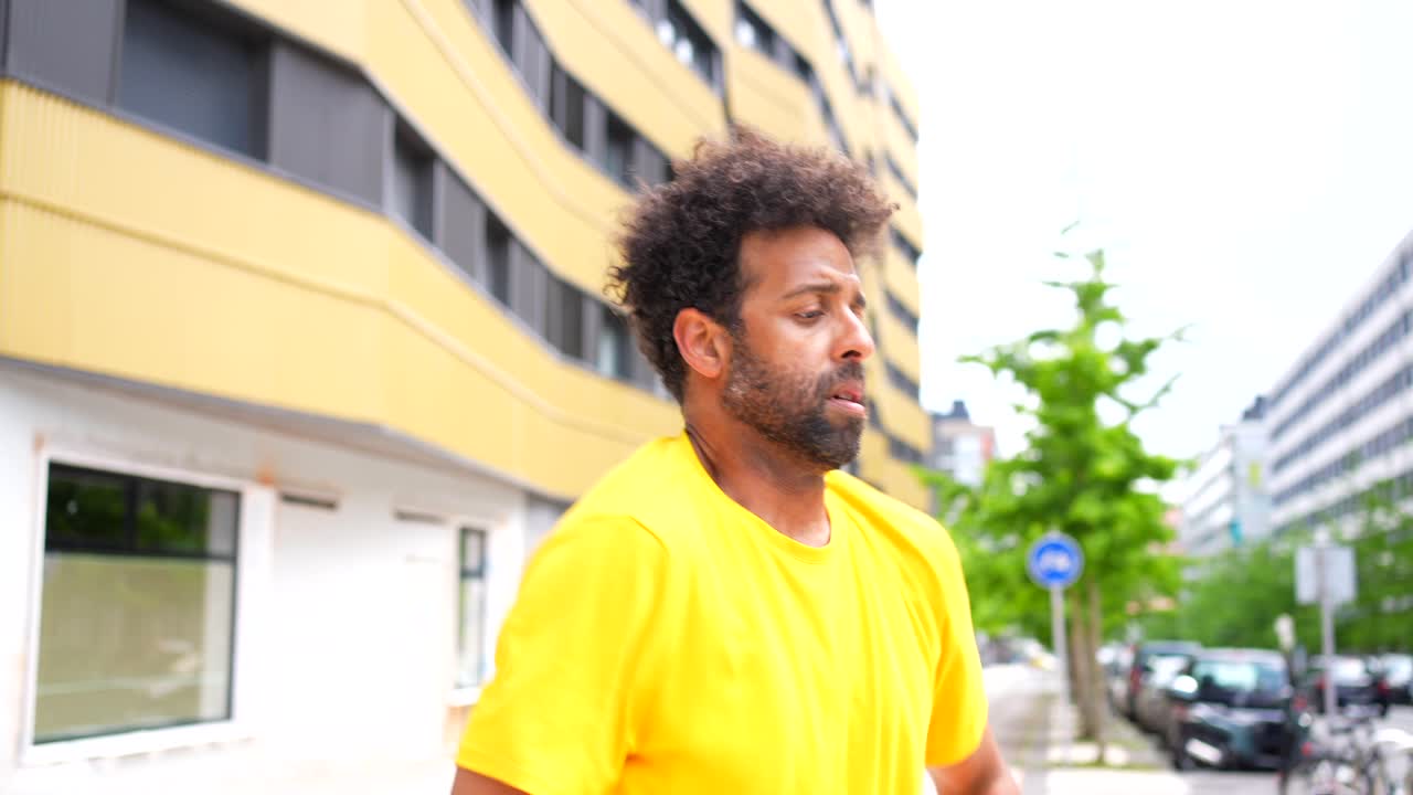 A man in a yellow shirt outdoors