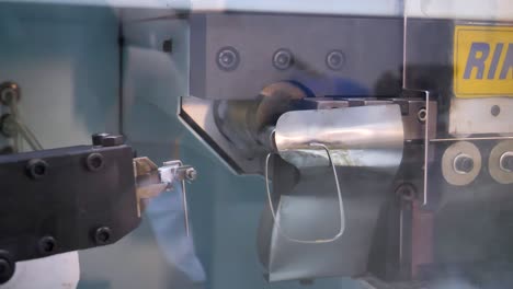 close-up of a metal frame bending machine in a lens factory in jiangsu province, china, demonstrating precision and advanced manufacturing techniques.