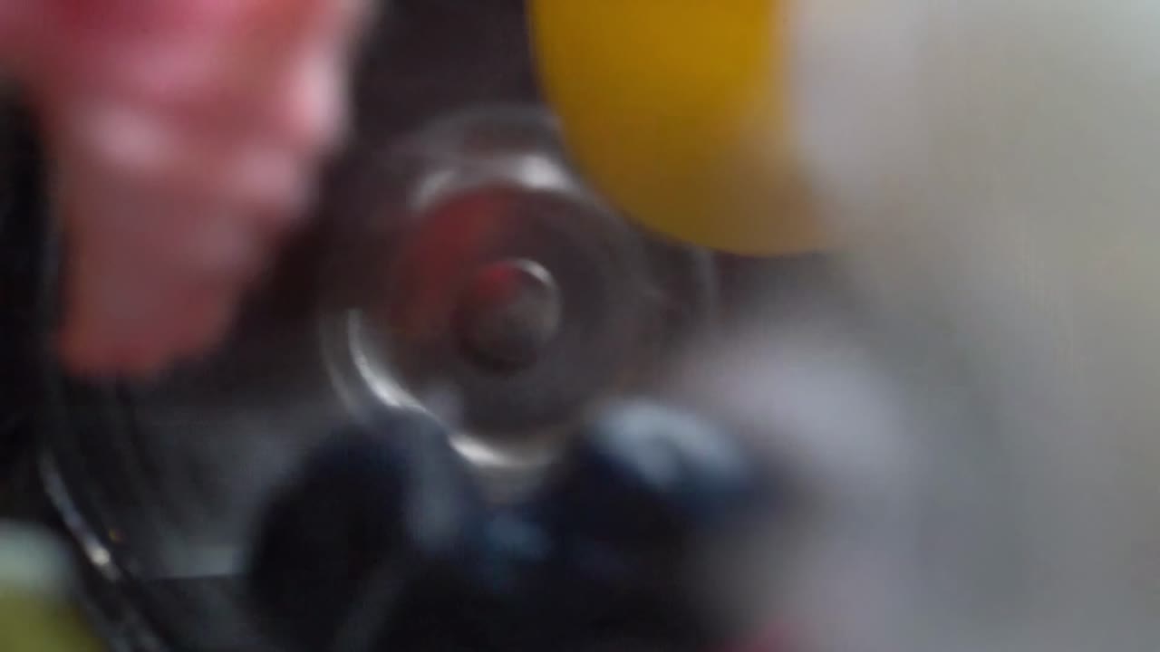 Top down view of plastic toys pulverized in a blender, symbolizing waste and pollution