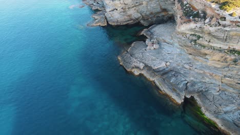 aerial view of blue water and rock of cala escondida with, spain