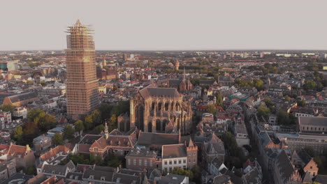 aerial view of the city centre of the dutch medieval city of utrecht in the netherlands at sunrise revealing the cathedral tower in scaffolds