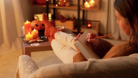 woman writing in a notebook during halloween