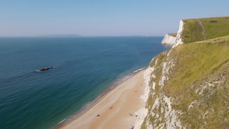People-relaxing-at-Durdle-Door-beach-in-Dorset,-England