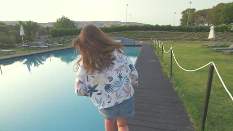 woman jumping into a swimming pool