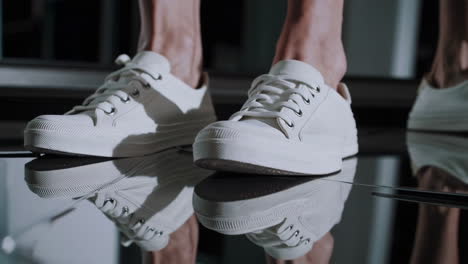 white sneakers on a reflective surface