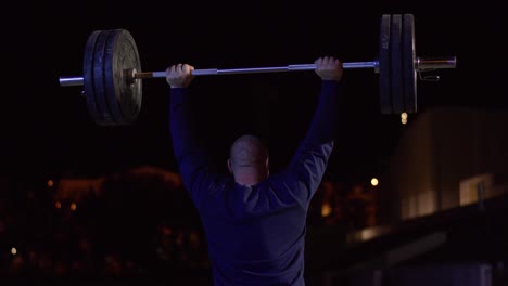 man weightlifting at night