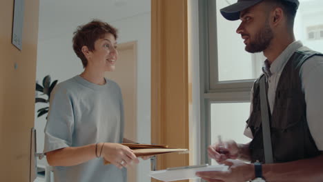 young woman receiving express mail from courier