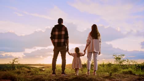 family enjoying a sunset view