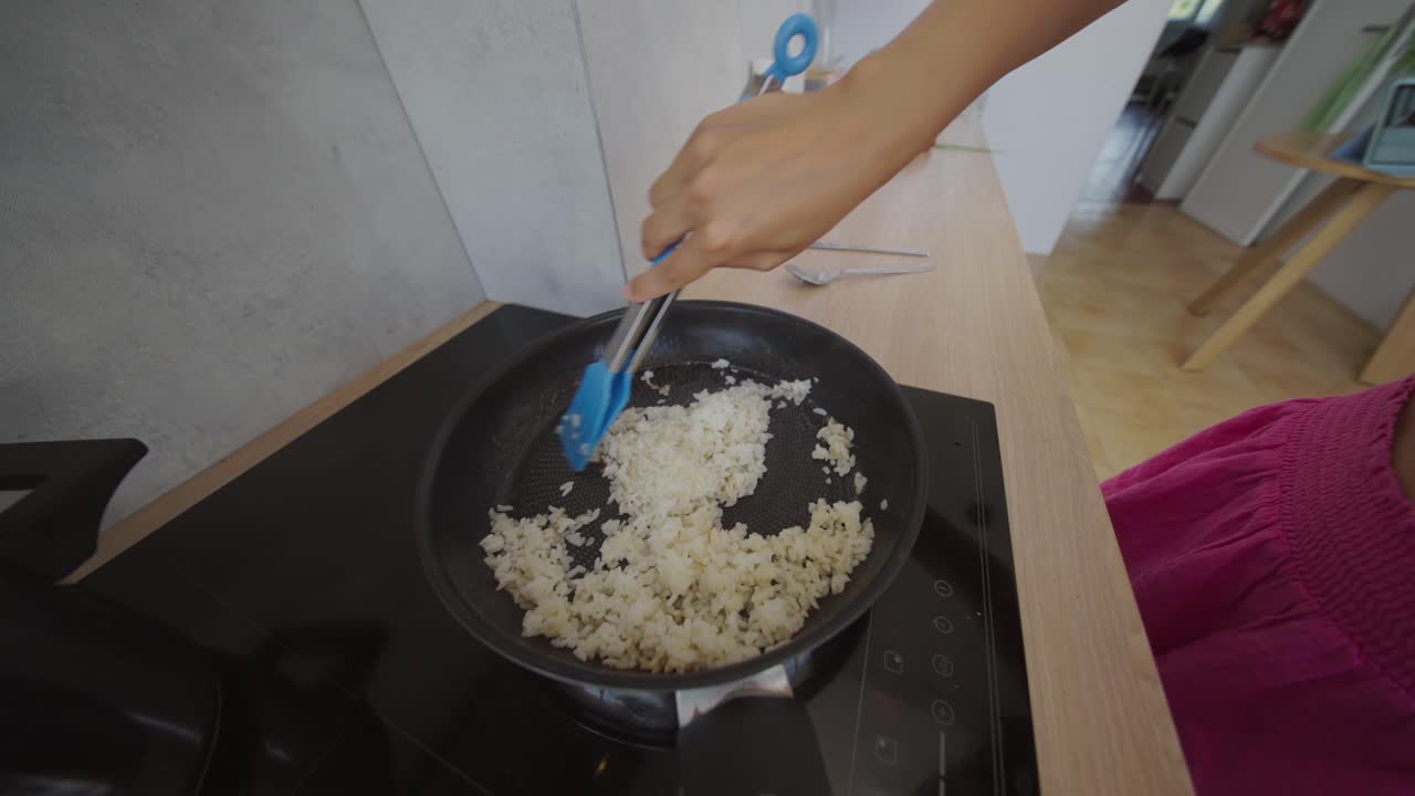 Cooking Rice in a Frying Pan on a Stovetop