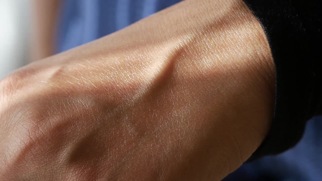 Close-up of skin and veins with dripping liquid