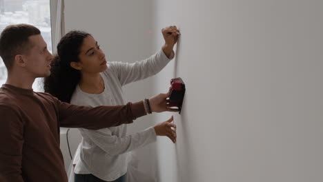 couple using laser level for home improvement project