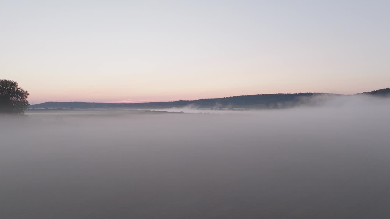 Misty Sunrise over a Peaceful Field