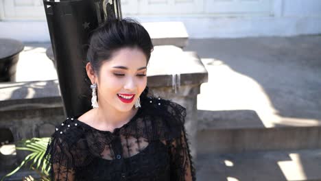 portrait of young asian woman smiling and looking at camera, slow motion
