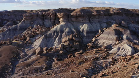 Drone-rotating-over-a-dusty-badland-on-a-sunny-day