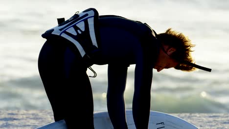 male surfer with surfboard in the beach 4k