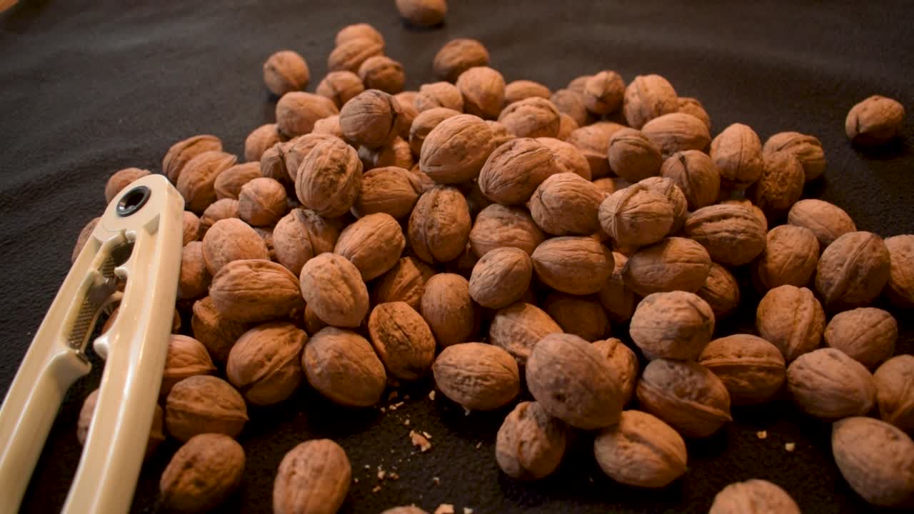 Young man is cracking some fresh dried walnuts-2