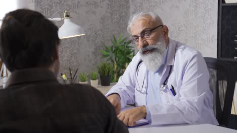 senior mature doctor talking to his patient.