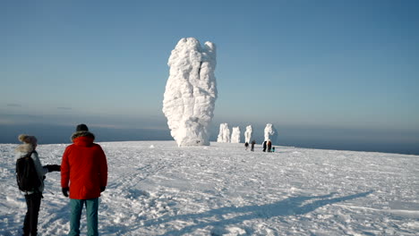 snowy mountain peaks with stone pillars