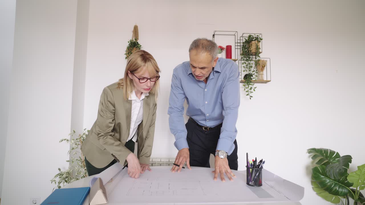 Architects collaborating on a blueprint