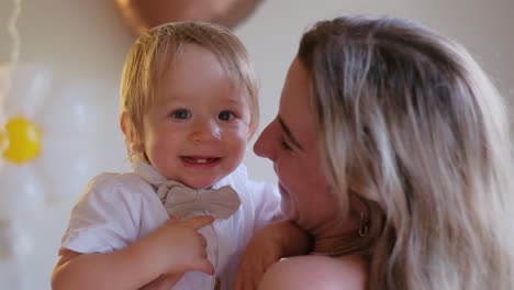 video of a woman and cute baby smiling creating a sweet moment heartwarming video of a woman holding a cute baby who smiles bites her finger and looks joyfully at the camera the woman smiles at the baby creating a sweet and tender moment