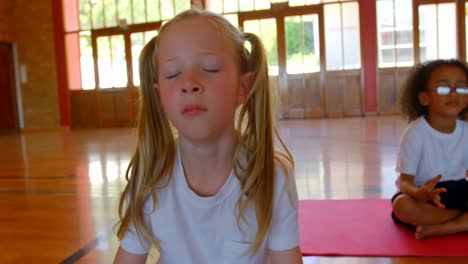 schoolkids performing yoga on a exercise mat in school 4k