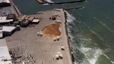 aerial view of a coastal urban beach with restaurants