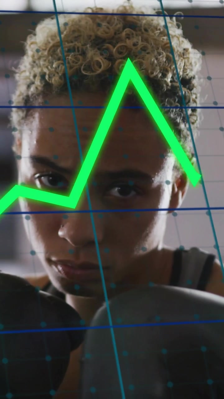 Vertical video: Woman boxer punching guard, causing blue-grid neon lines tracking gloves for sports