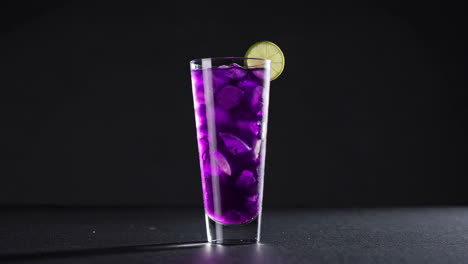 vibrant purple drink with lime slice