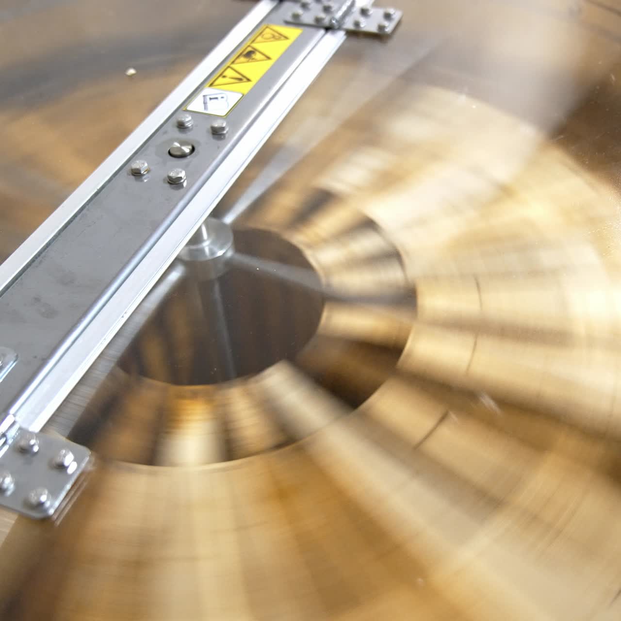 Centrifuge device working. Honey frames being rotated inside the apparatus for extracting honey harvest. Close up