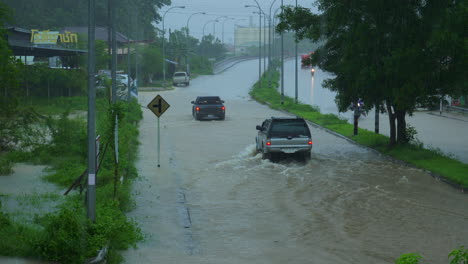 cars driving and evacuating through an overflown road