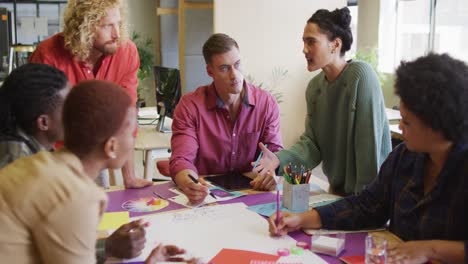 happy diverse business people discussing work during meeting at office