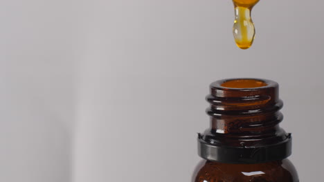 amber bottle of essential oil with dropper