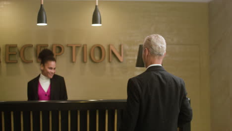 receptionist checking in a guest