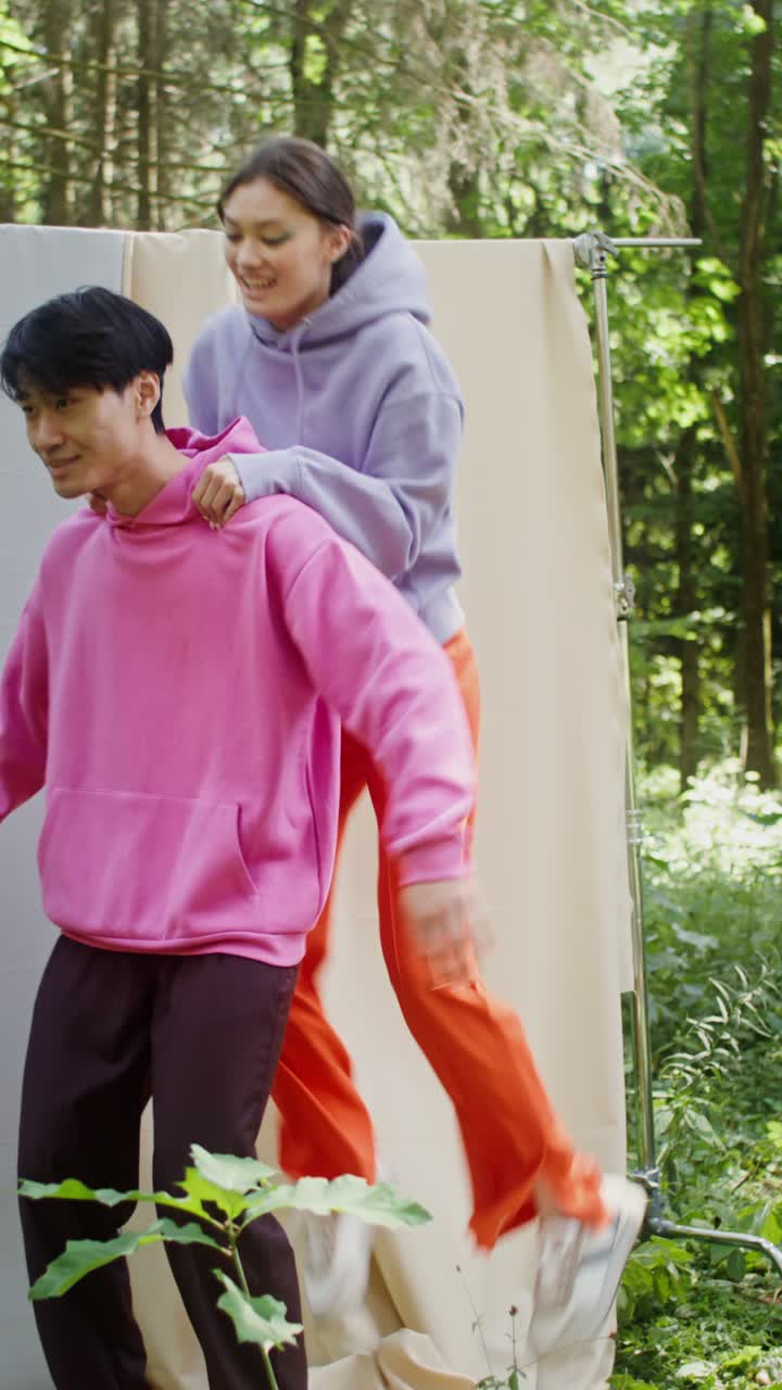 Couple Having Fun with a Piggyback Ride in the Forest