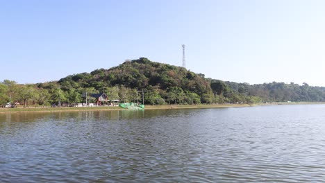 steady view across a tranquil lake and hill