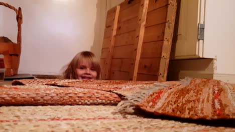 vintage archive shot of little girl peeping out of basement floor hatch