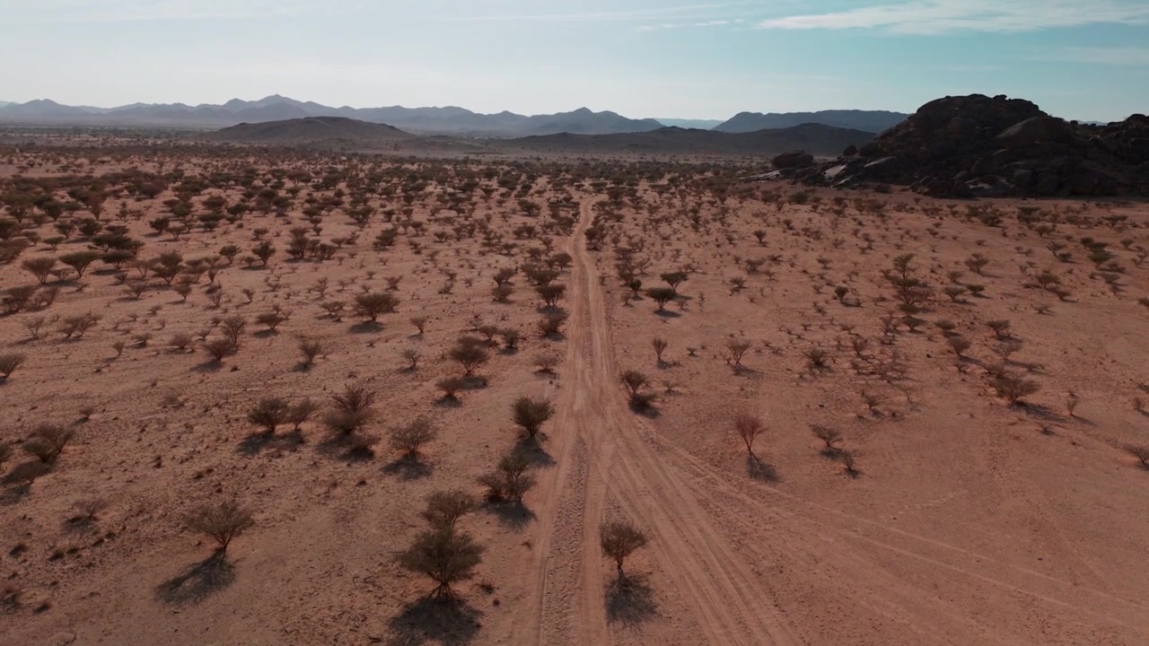 Drone wide shot of trails in rocky desert